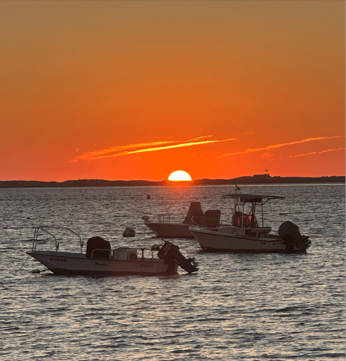 Sunset over Madket Harbor with 3 boats in the water Sunset over Madket Harbor with 3 boats in the water